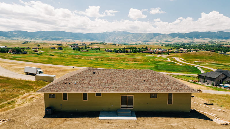 Back exterior view of custom home build with view of Grand Tetons