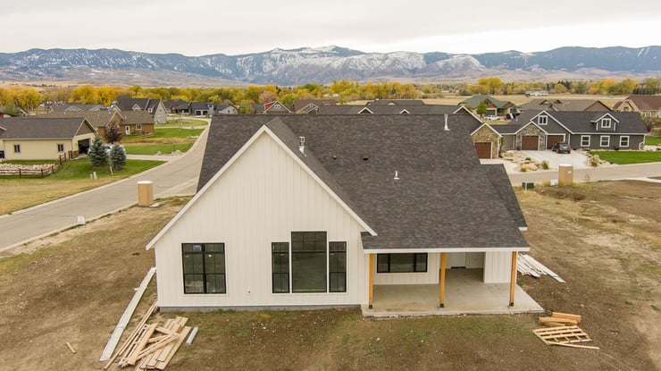 custom home exterior construction progress with mountain view