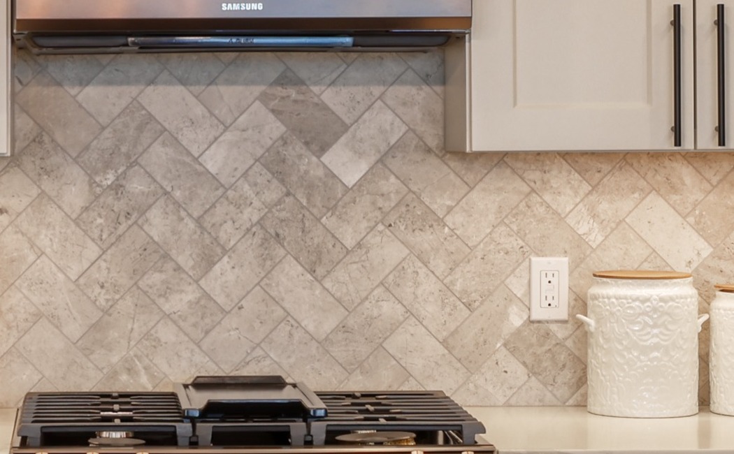 Tile kitchen backsplash behind cooktop