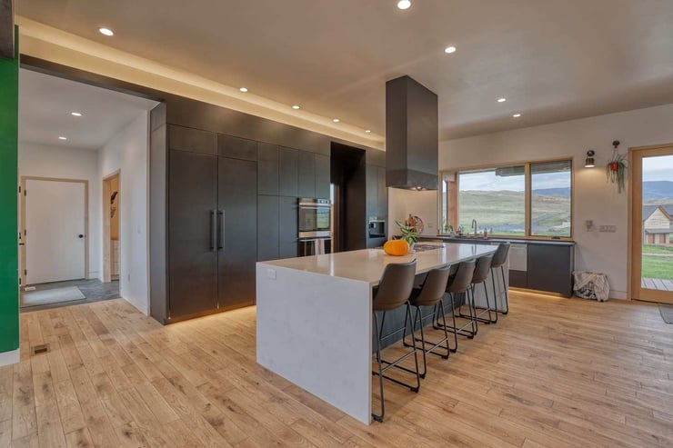 Open-concept custom kitchen interior in Wyoming custom home with flat panel cabinets