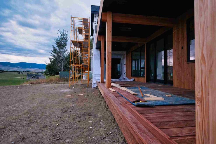 Construction progress of new home exterior with wood beams