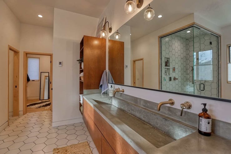 Extended bathroom vanity with trough sink and double faucets