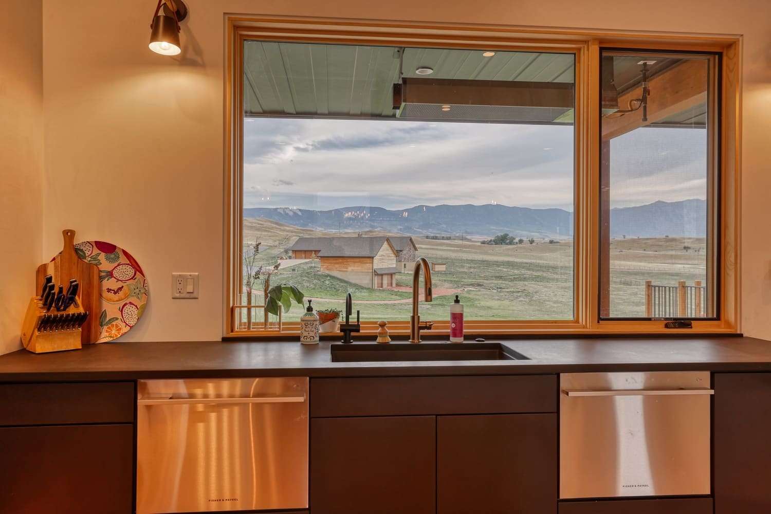 Kitchen sink view near window with double dishwashers built in
