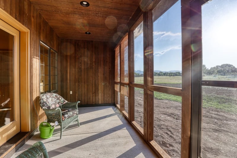 Custom sunroom with floor-to-ceiling windows and wood paneling