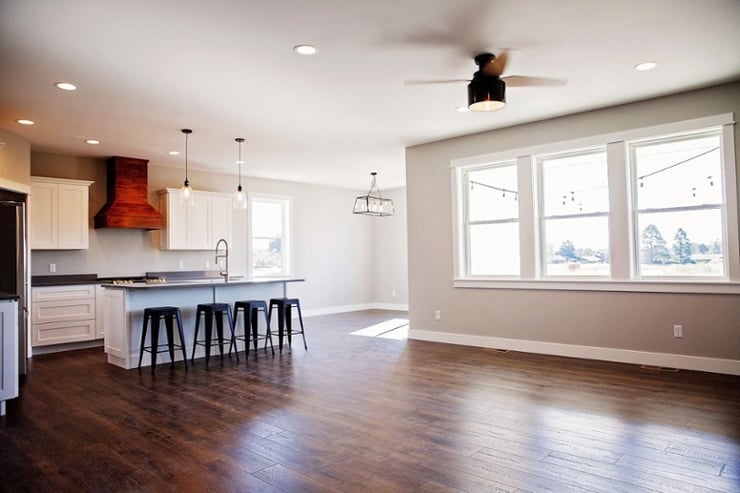 Open concept main floor layout with natural light and modern kitchen