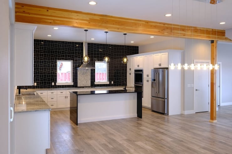 Contemporary custom kitchen with black tile backsplash and island