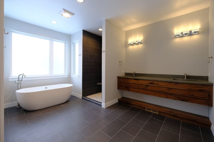 Custom luxury bathroom with double floating vanity and walk in shower and tub by window