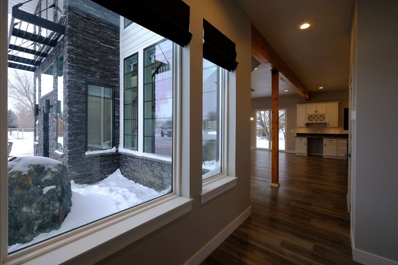 Windows in custom home showing exterior in snow with recessed lighting