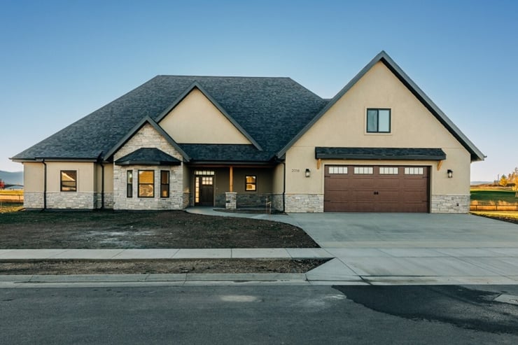 Custom home front view of exterior with attached garage 