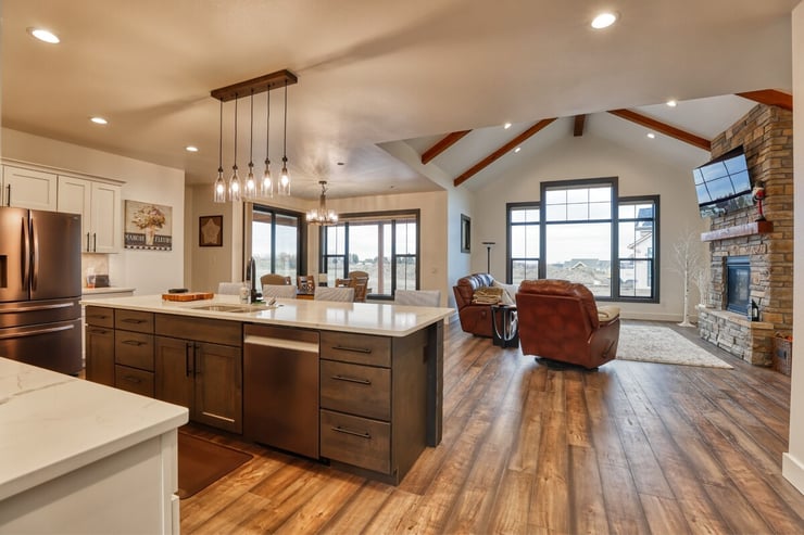 Custom home kitchen and living area with vaulted beamed ceiling in wyoming