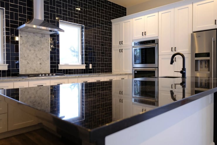 custom home kitchen with black subway tile backsplash tile in wyoming