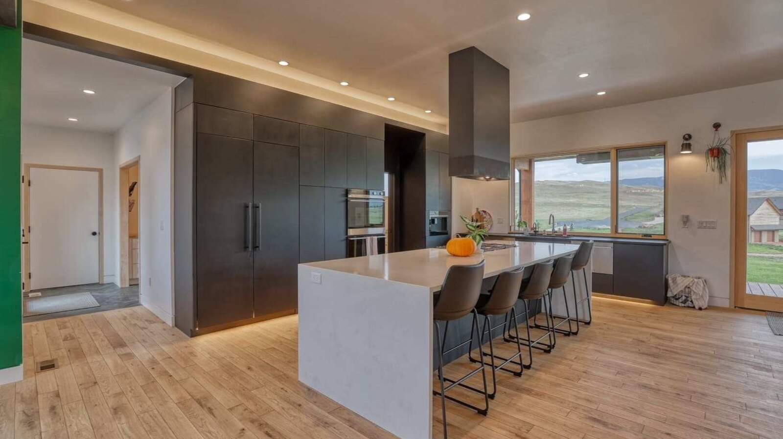 Custom kitchen with island and floating range hood