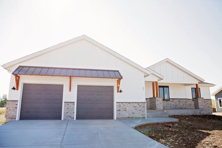 Exterior of one-story custom home with attached two-car garage