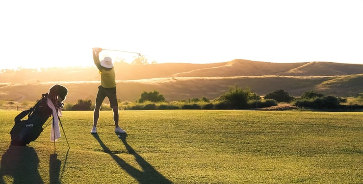 Golfer on back swing on golf course in Wyoming
