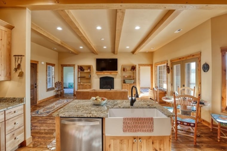 kitchen island with farmhouse sink beamed ceiling in wyoming