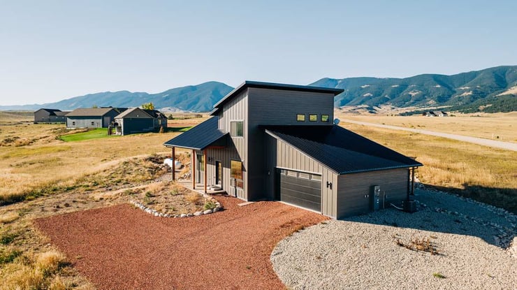 Wyoming custom home exterior with grey siding and black roof