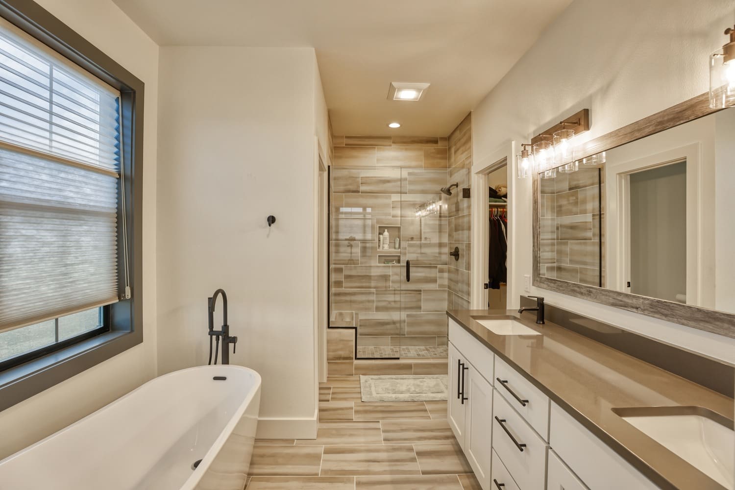 luxury bathroom in custom home with soaker tub and walk-in shower