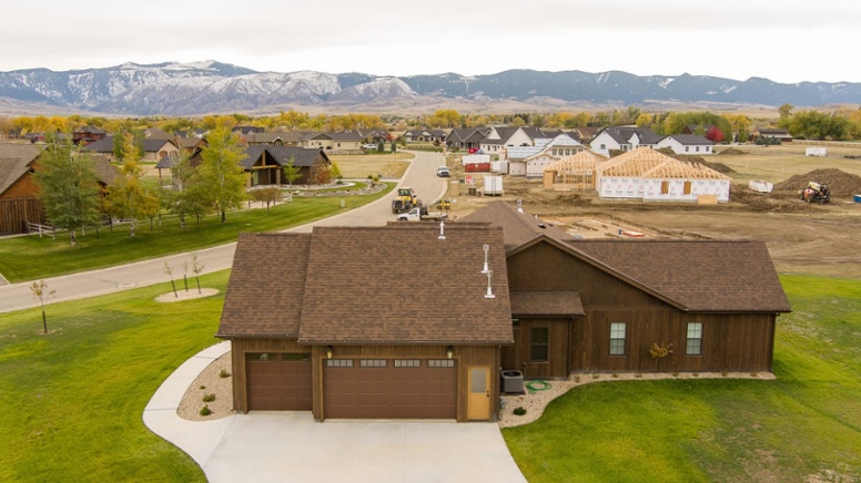 front-exterior-of-custom-home-with-two-car-garage-and-wyoming-landscape-in-back-1