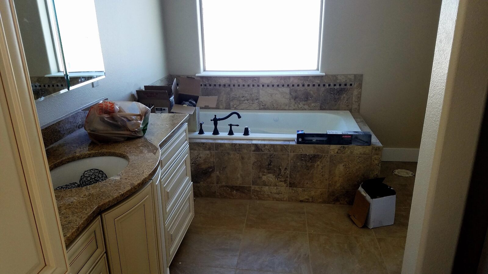 bath tub with tiles being installed in custom home in wyoming