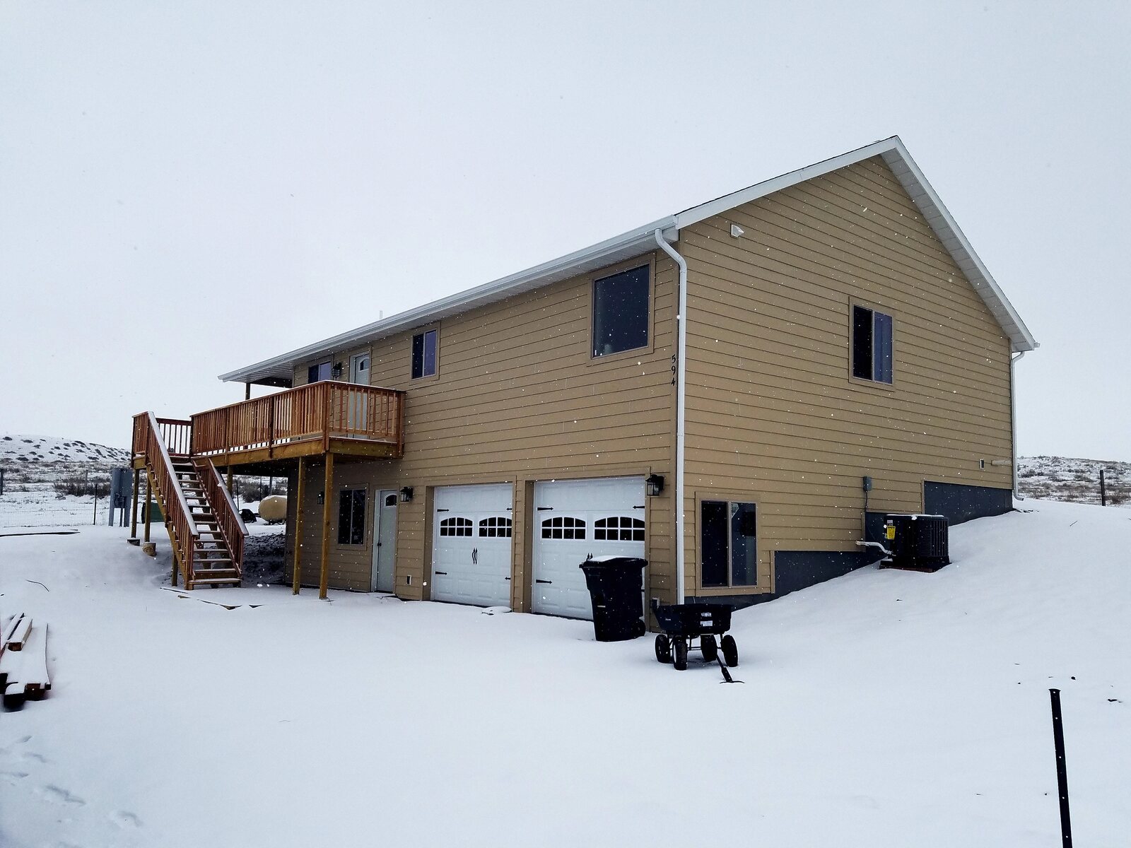custom home exterior during snow in wyoming