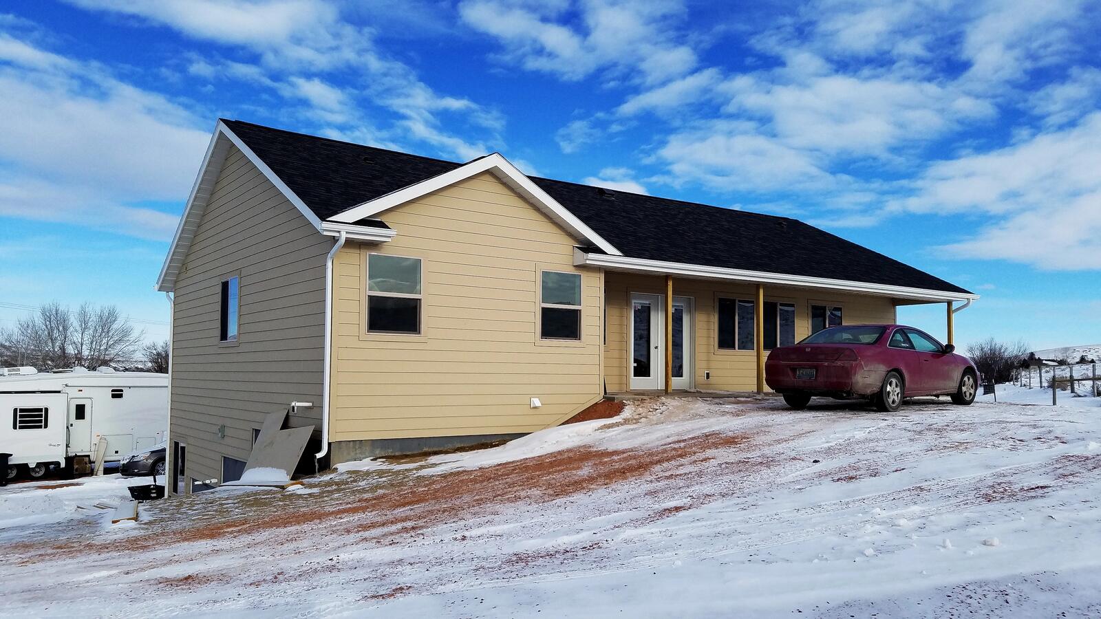 custom home exterior with snow in wyoming