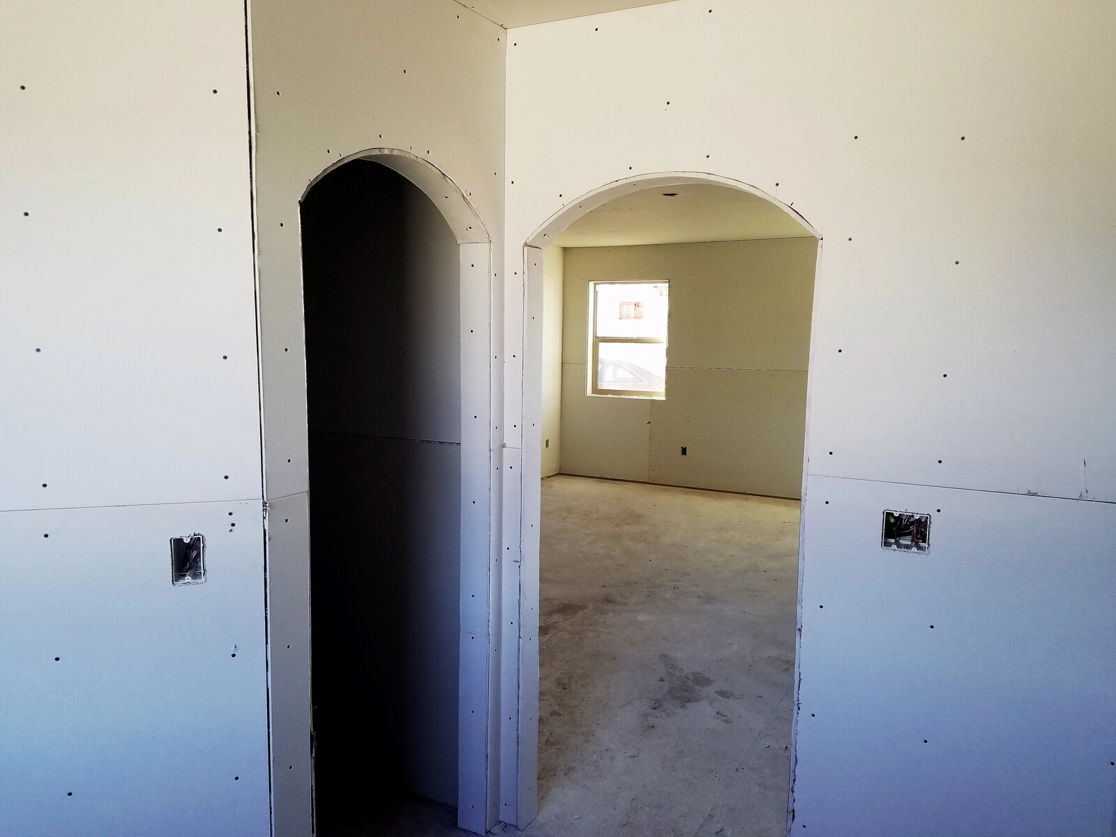 inside custom home being built with drywall and two doorways in wyoming