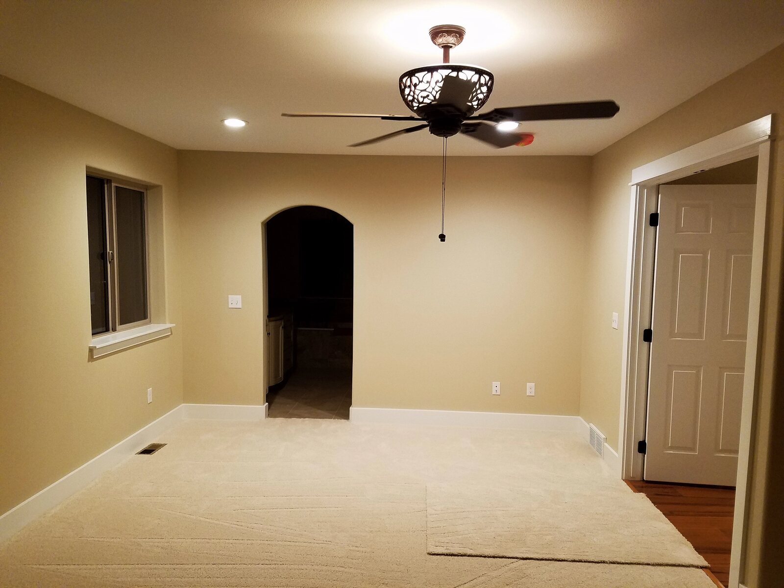 living room with ceiling fan in wyoming custom home