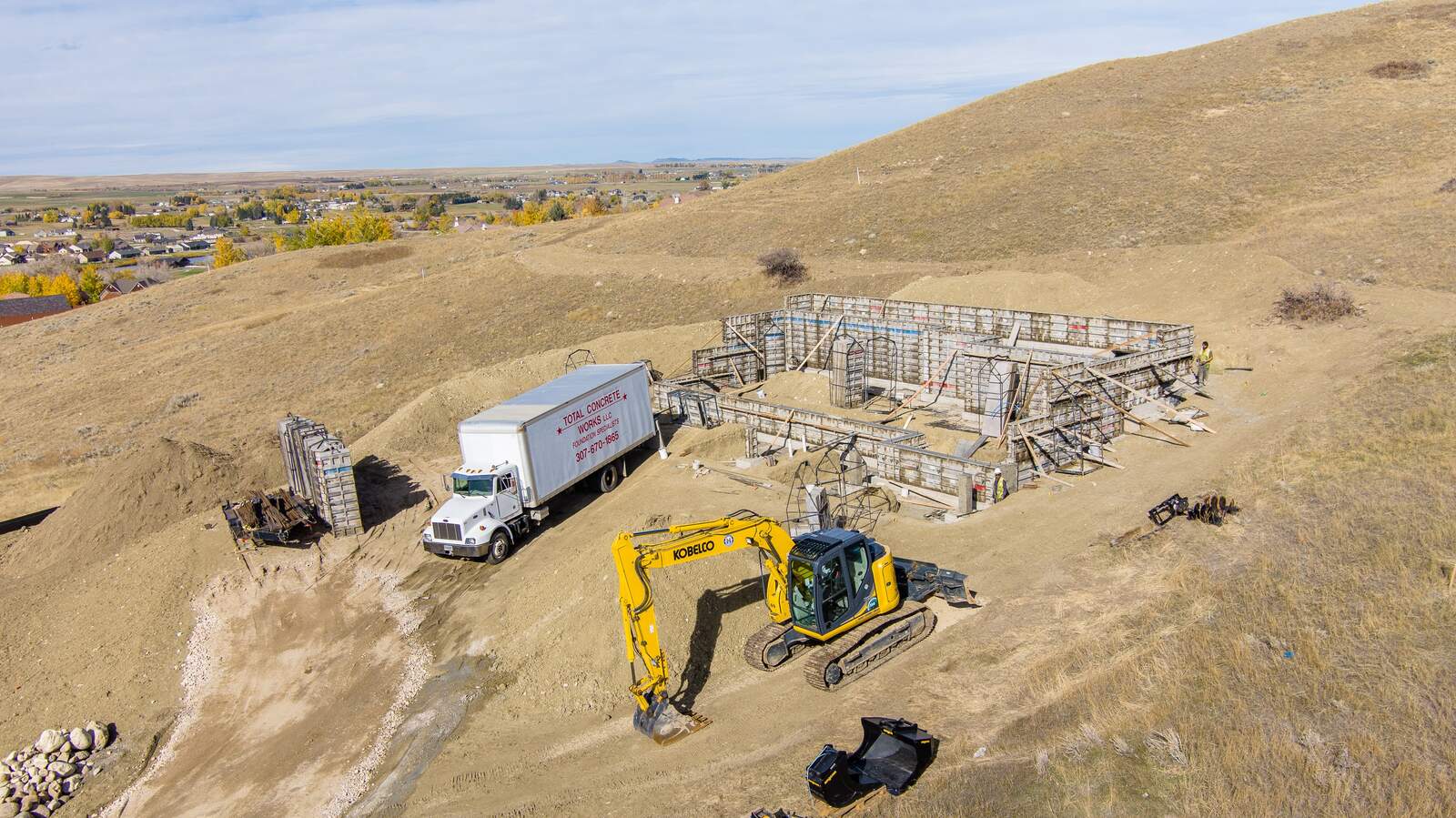 aerial custom home being built and construction happening in wyoming