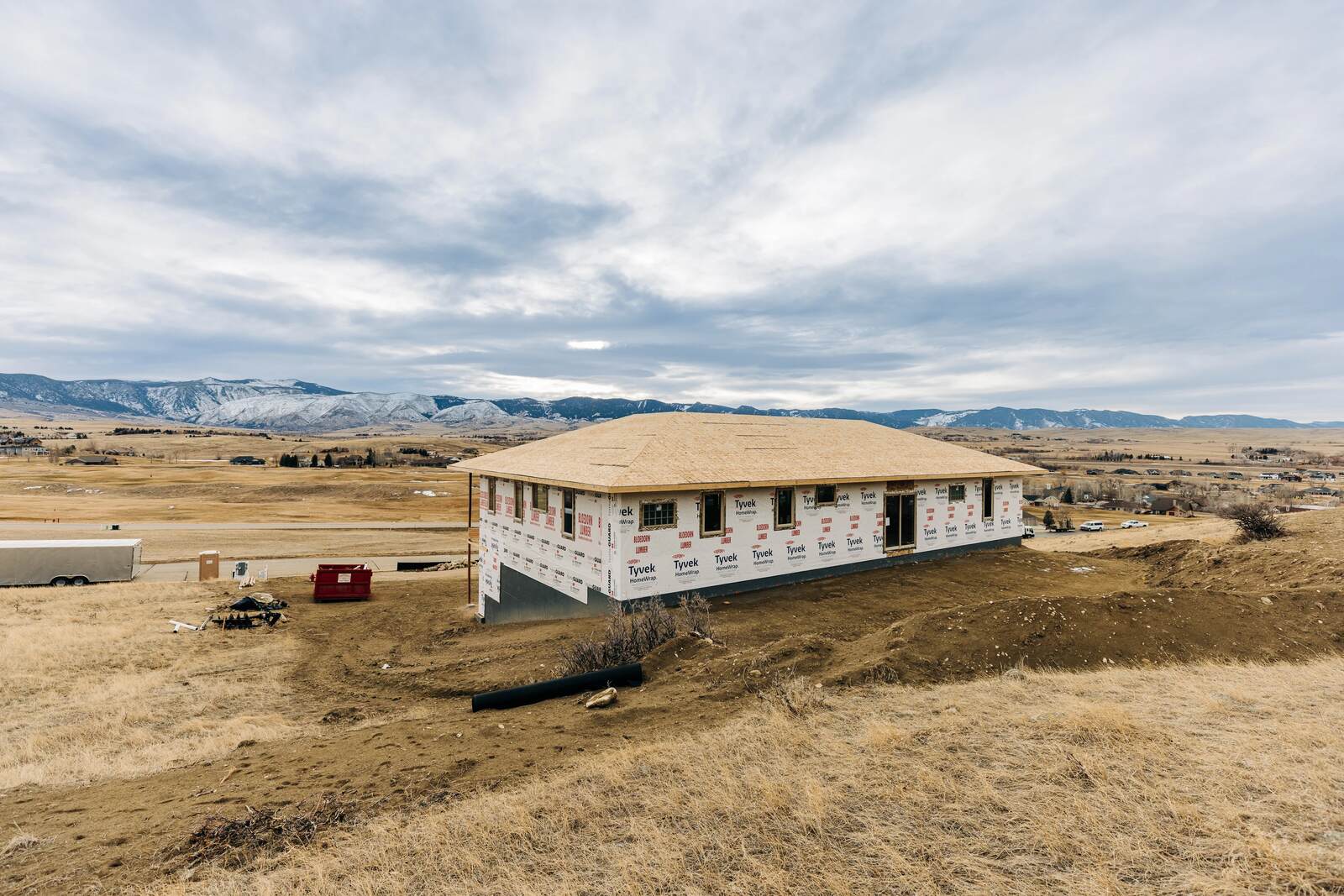custom home exterior frame done in wyoming with mountains in background