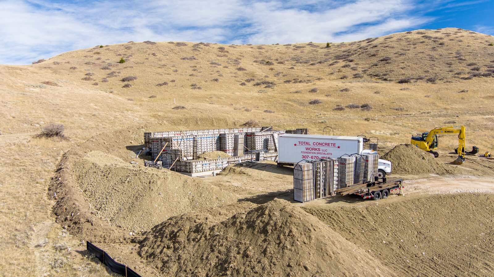 custom home framing being built on a hill in wyoming