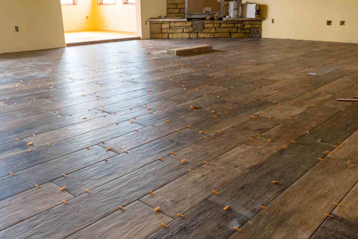 Luxury vinyl plank flooring installation in living room area of custom home