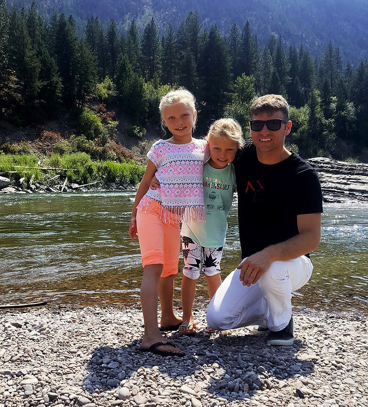 Drew Homola and daughters at a mountain lake