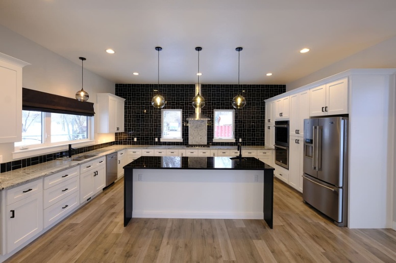 custom-kitchen-design-with-island-beneath-three-pendant-glass-light-fixtures-1