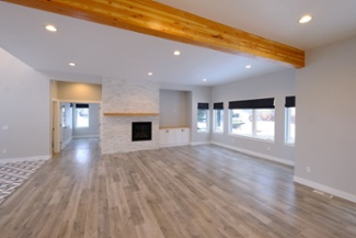 great-room-in-open-concept-custom-home-with-wood-ceiling-beam-and-recessed-lighting-1
