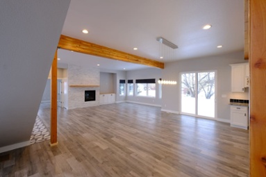 main-floor-interior-of-custom-home-with-fireplace-and-wood-beam-posts-1