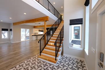 staircase-with-black-railing-in-entryway-of-custom-home-1