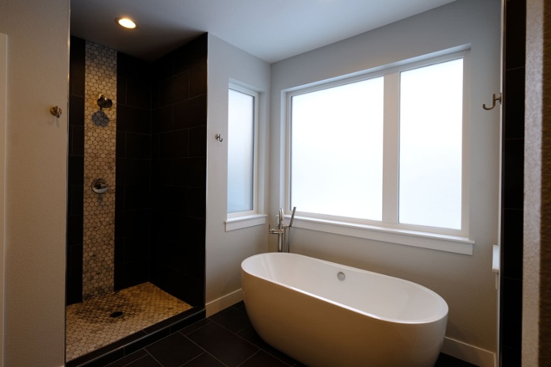 walk-in-shower-and-white-soaking-tub-by-window-in-bathroom-1