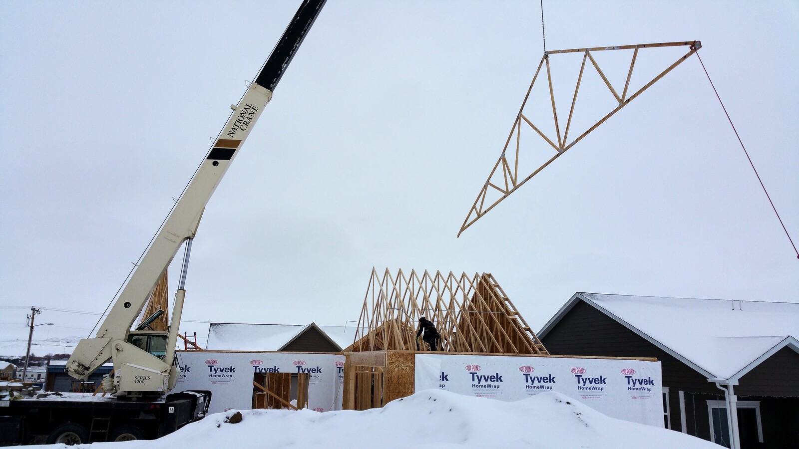 building a custom home framing with crane and roof in wyoming winter