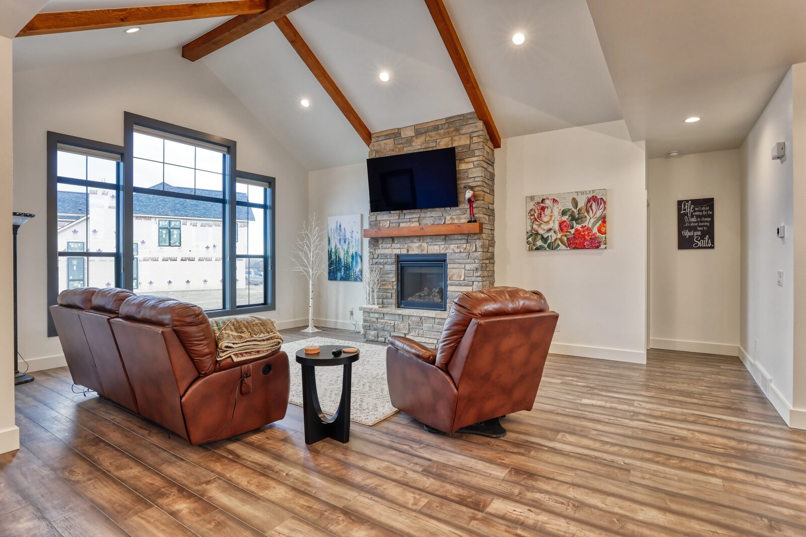 custom home beamed ceiling living room with furniture in wyoming