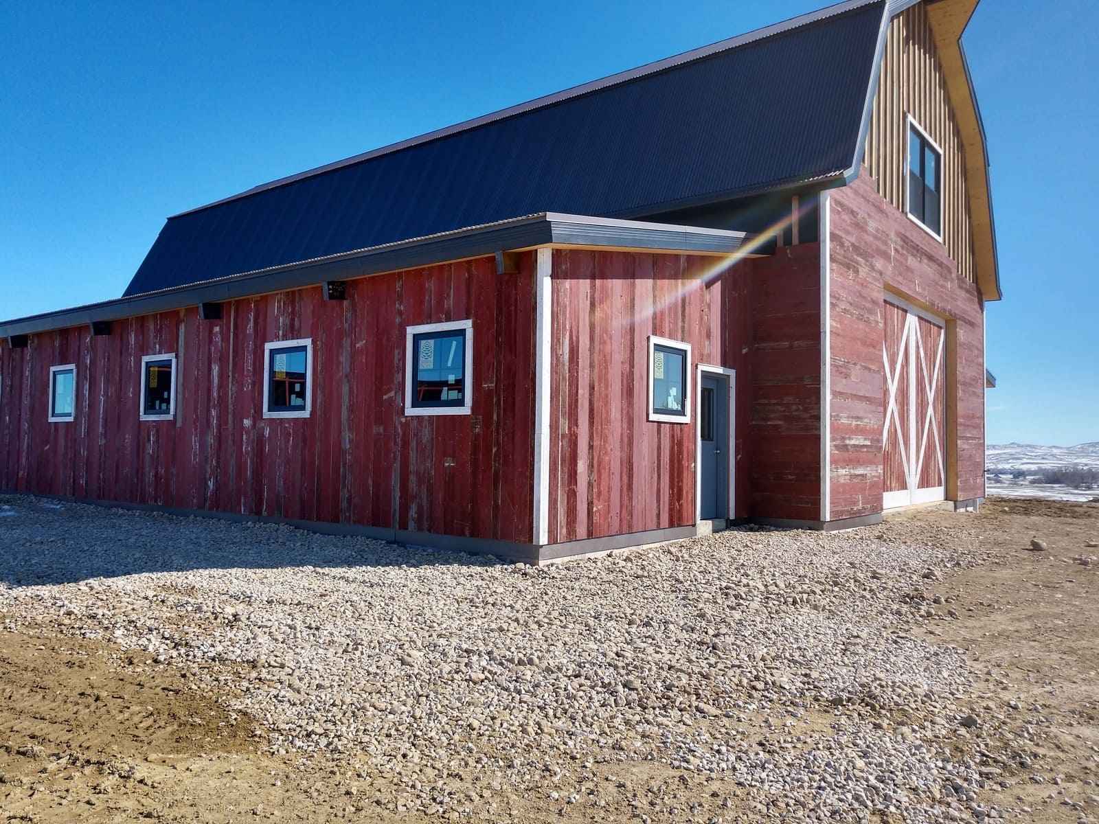 Custom barn side exterior with new windows and reclaimed wood