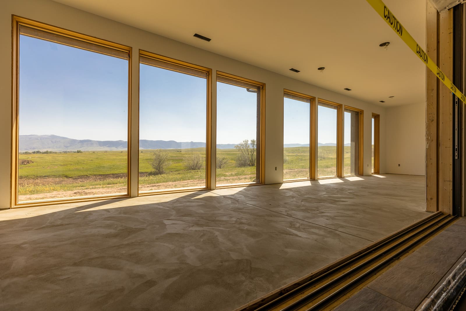 Floor-to-ceiling windows in custom home build during construction