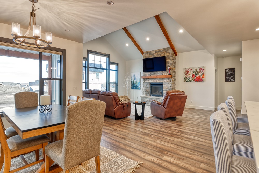 living room area with shed cieling and pendant lighting in wyoming custom home