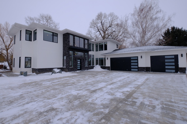 white contemporary custom home exterior in winter