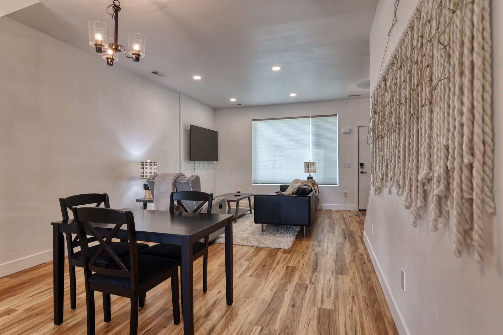 wood floor living room with wall mounted tv in custom home in wyoming